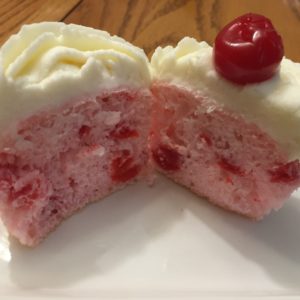 photo of a cut in half cherry almond cupcake from cocos confections